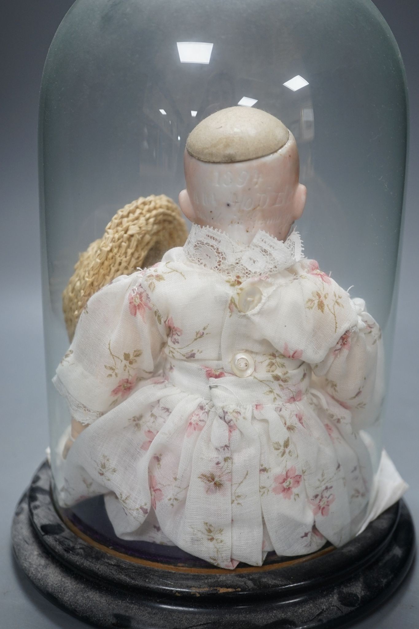 An Armand Marseille bisque doll, mould 1894, under glass dome 29cm